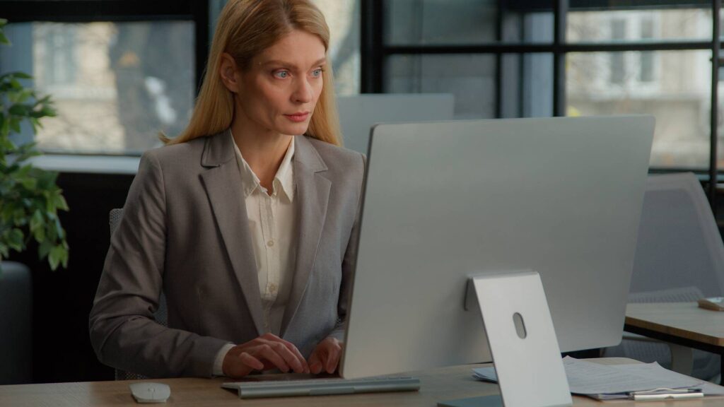caucasian-middle-aged-woman-in-office-working-with